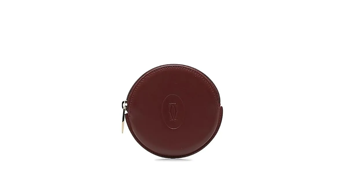 Estuche redondo de cuero rojo vino de la línea Must de Cartier en muy buen estado Roja 