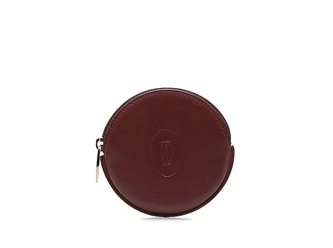 Estuche redondo de cuero rojo vino de la línea Must de Cartier en muy buen estado Roja 