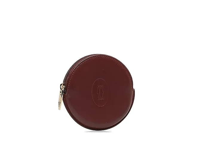 Estuche redondo de cuero rojo vino de la línea Must de Cartier en muy buen estado Roja 