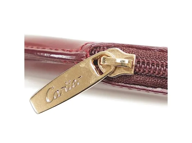 Estuche redondo de cuero rojo vino de la línea Must de Cartier en muy buen estado Roja 