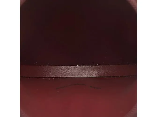 Estuche redondo de cuero rojo vino de la línea Must de Cartier en muy buen estado Roja 