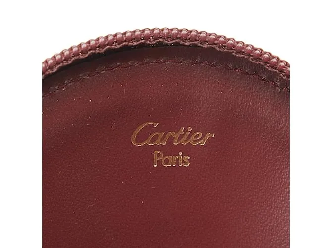 Estuche redondo de cuero rojo vino de la línea Must de Cartier en muy buen estado Roja 