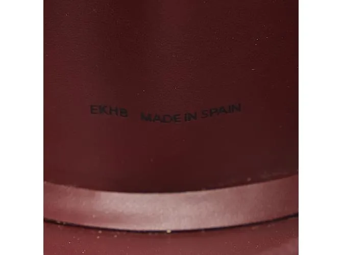 Estuche redondo de cuero rojo vino de la línea Must de Cartier en muy buen estado Roja 